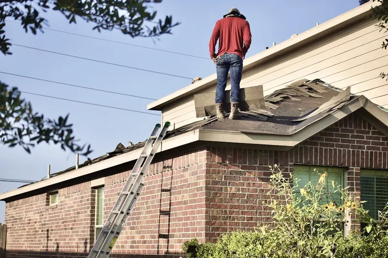 Professional roofer working on a residential roof in Warthen Knolls